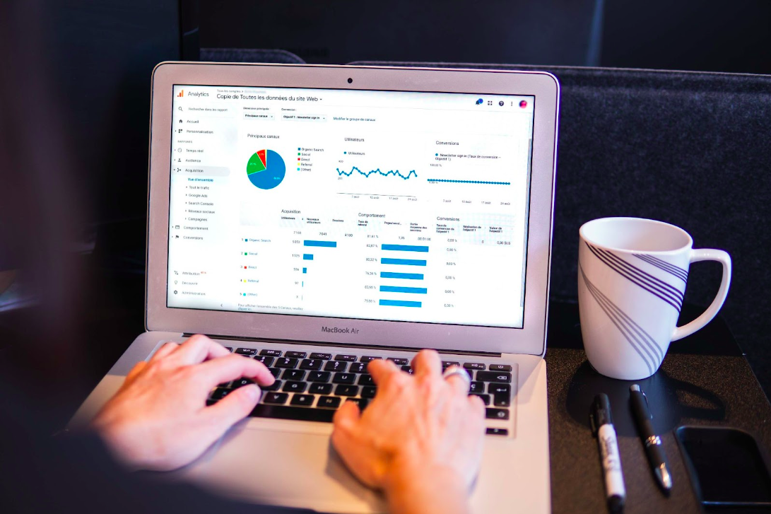 A data analyst at their laptop preparing visualizations to present findings